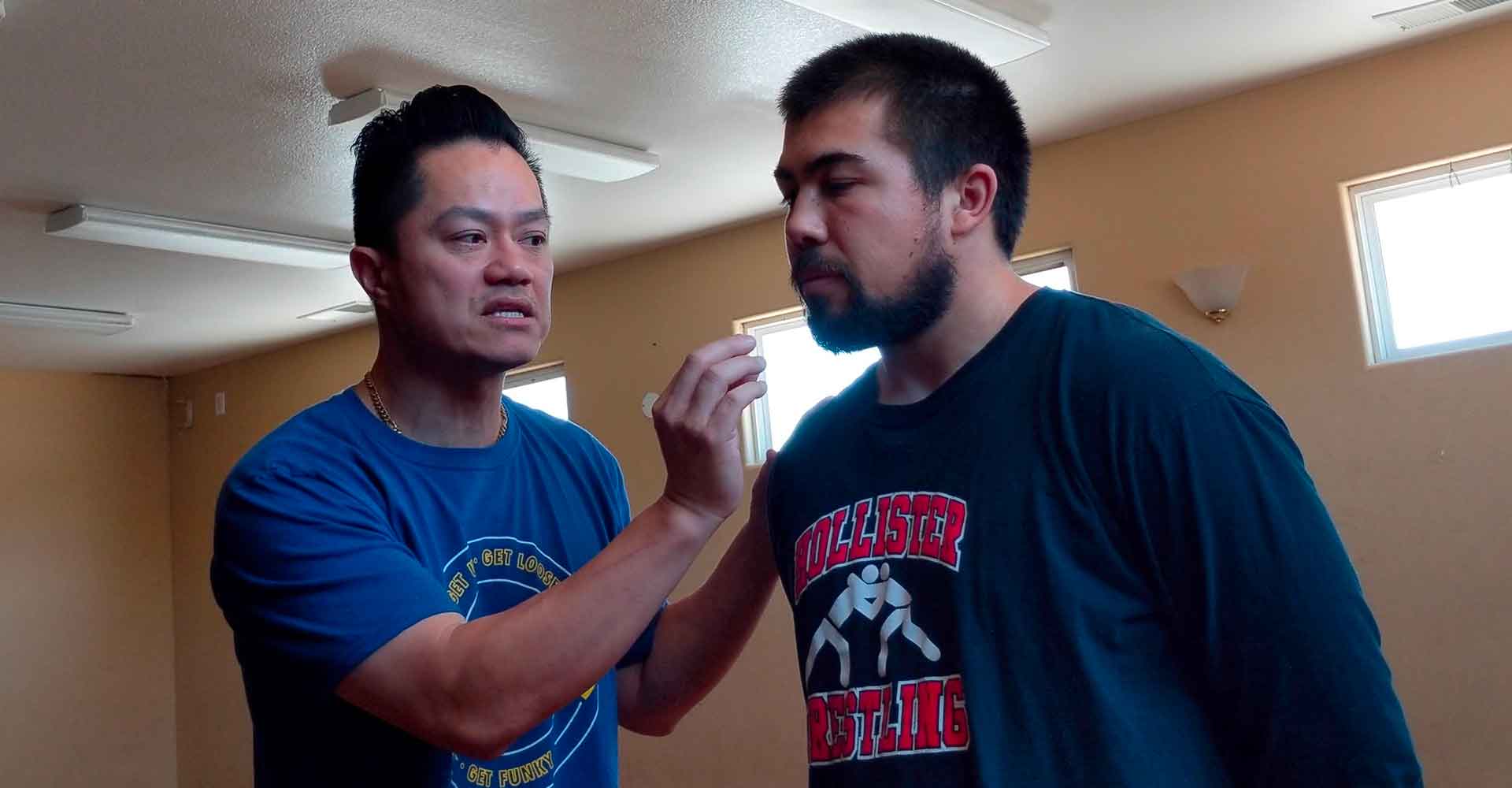 Ceech explaining a neck movement to a student during an in-person private lesson